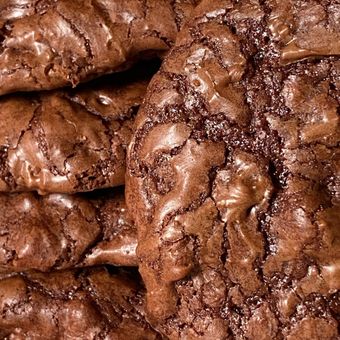 Close-up of stacked chocolate cookies with cracked, glossy tops