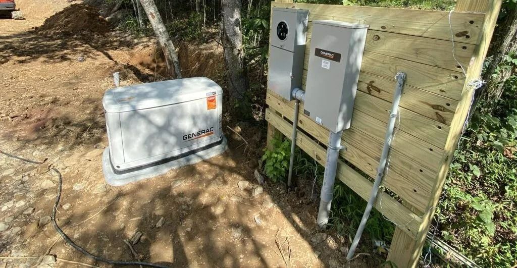Generator and electrical boxes on wooden platform in an outdoor setting.