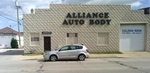 A car is parked in front of an auto shop