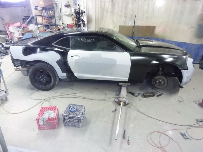 A black and white car is being repainted