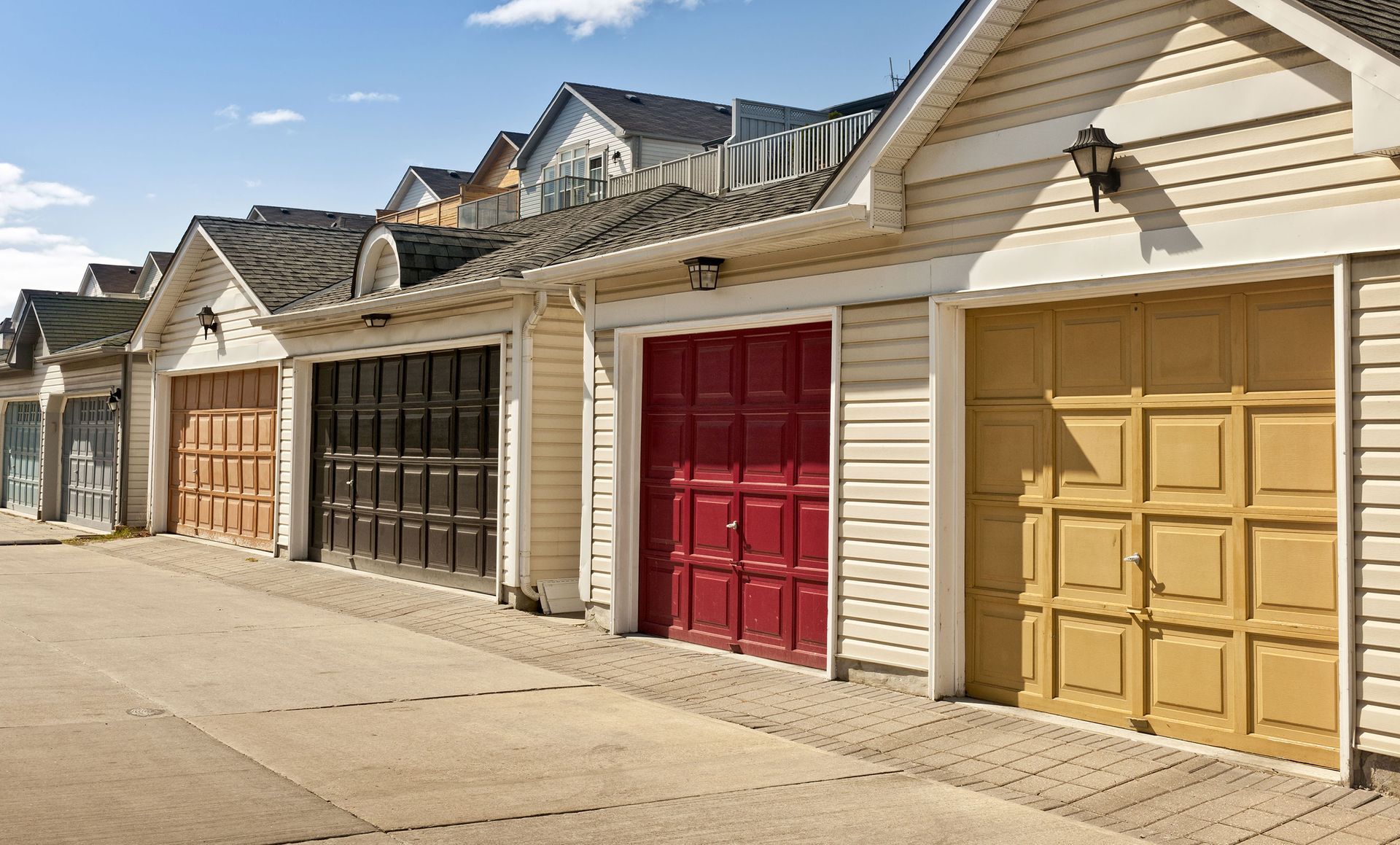 A row of garages with different colored doors