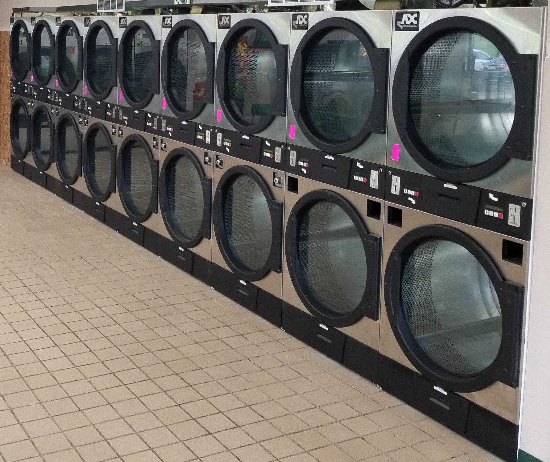 wall of washing machines in laundry mat