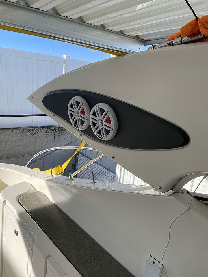 Two speakers are mounted on the side of a boat