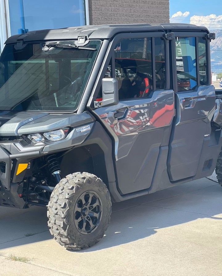A gray ATV is parked on the side of the road in front of a building