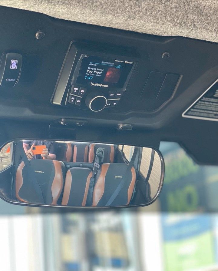 A car with a rearview mirror and a radio