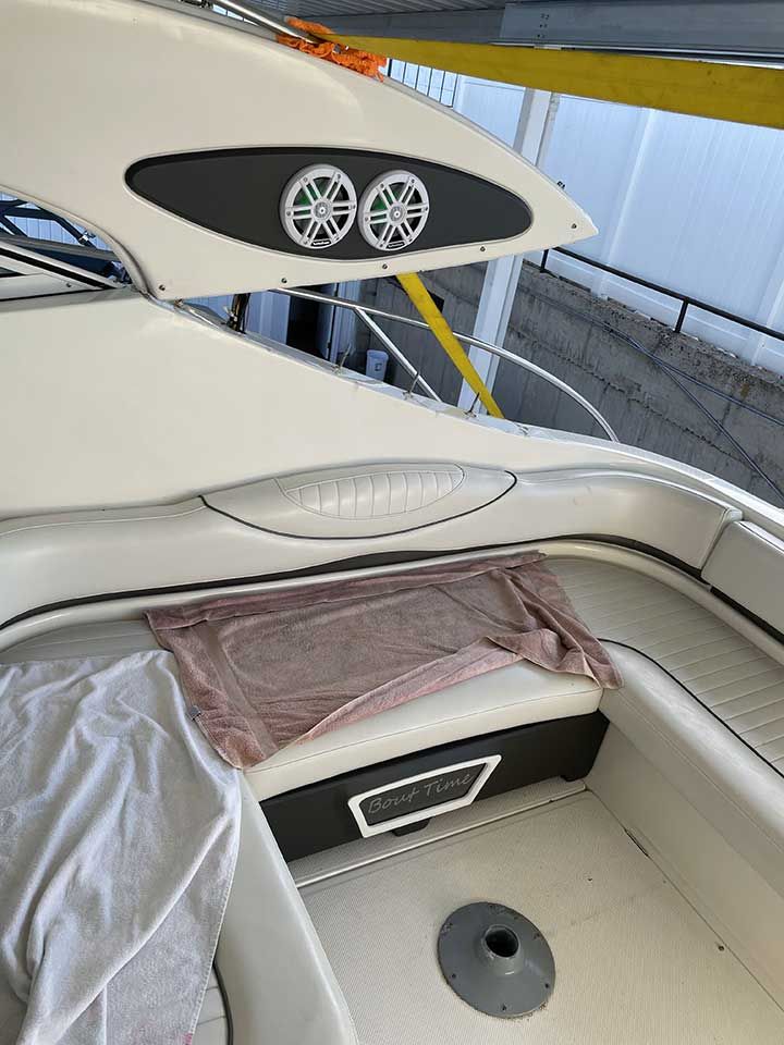 The back of a boat with a towel on the seat