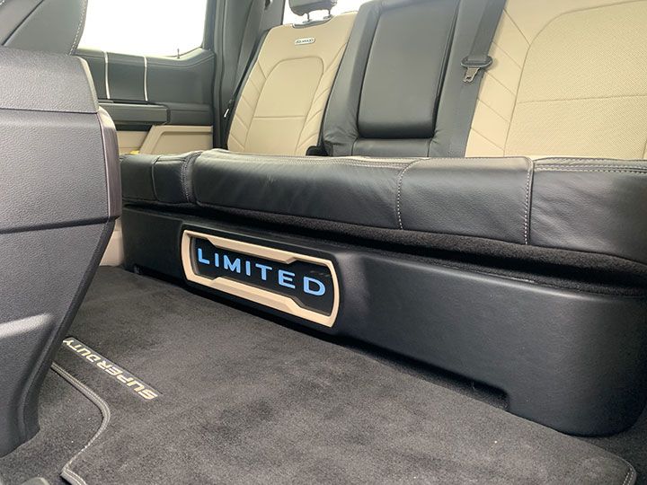 The back seat of a truck has a limited sign on it