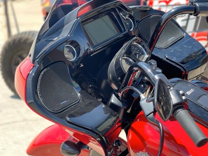 A close up of a red motorcycle with a black dashboard