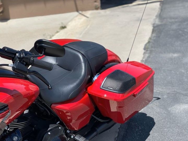 A red Harley-Davidson motorcycle is parked on the side of the road