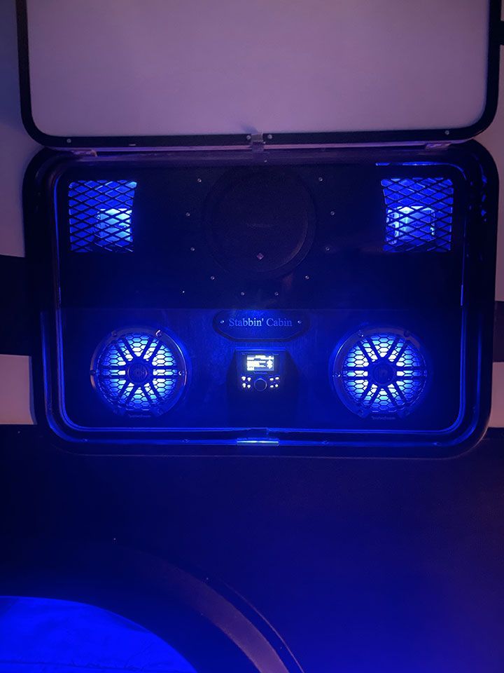 A close up of a speaker with blue lights on it