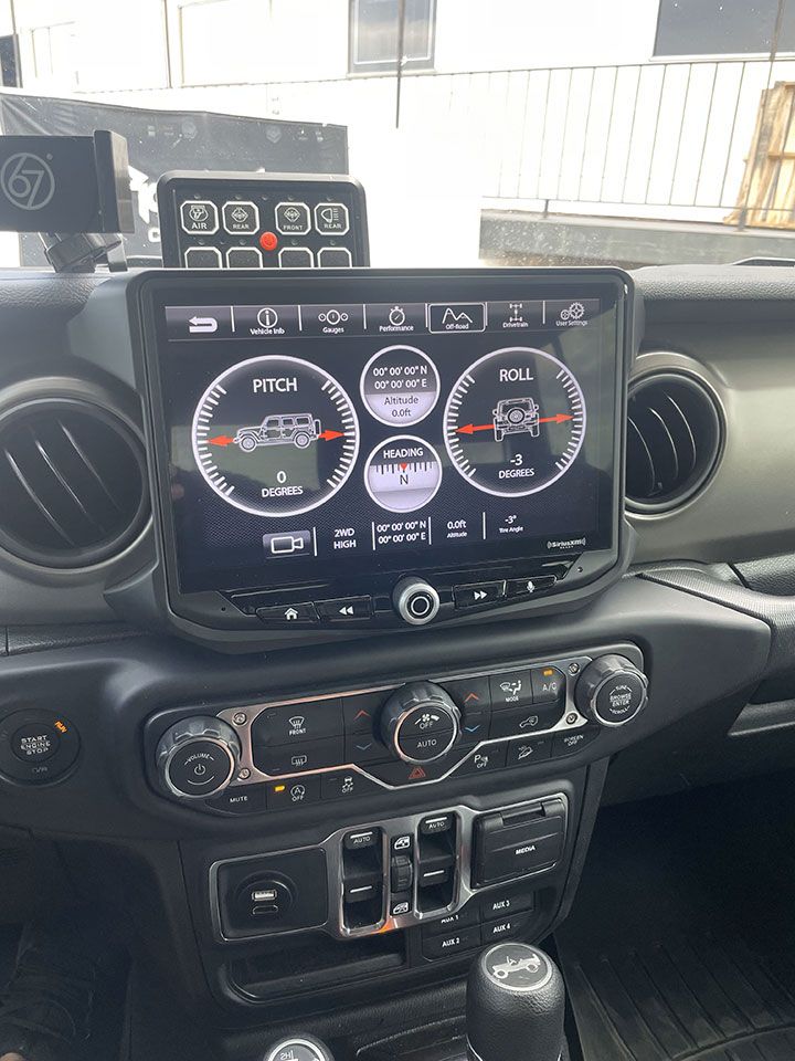 The dashboard of a Jeep Wrangler with a GPS on it