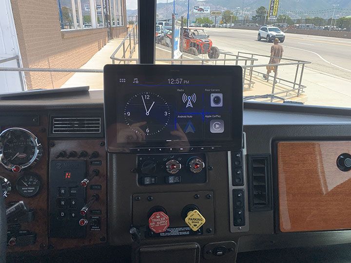 The dashboard of a truck with a clock on it