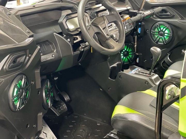 The interior of a vehicle with speakers and a steering wheel