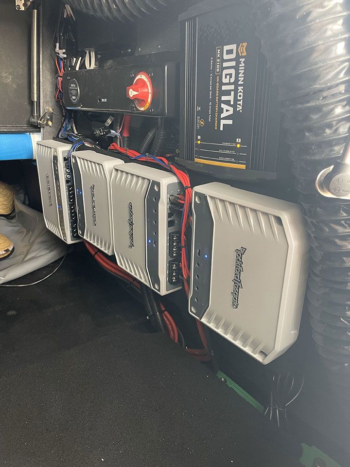 A row of speakers are sitting next to each other on a boat