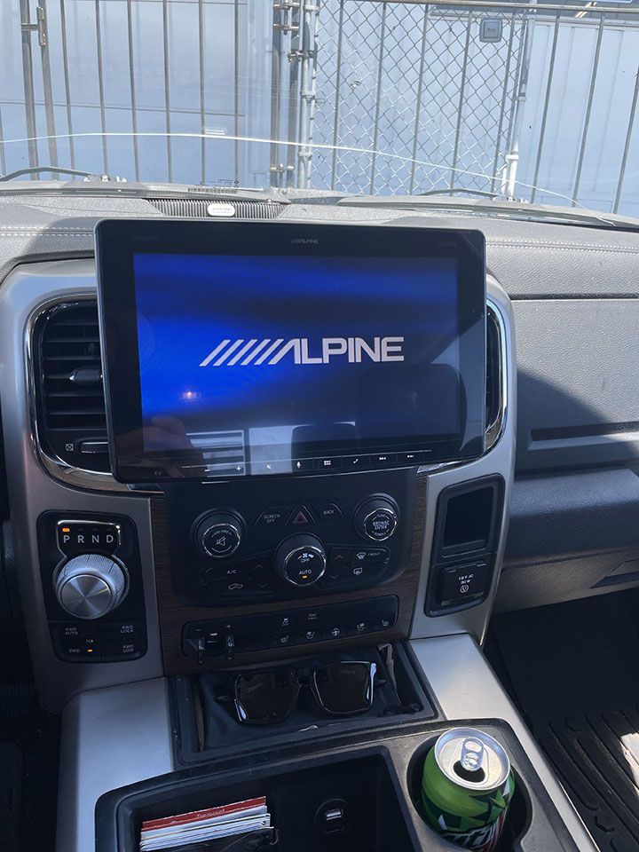 A car with an alpine radio on the dashboard