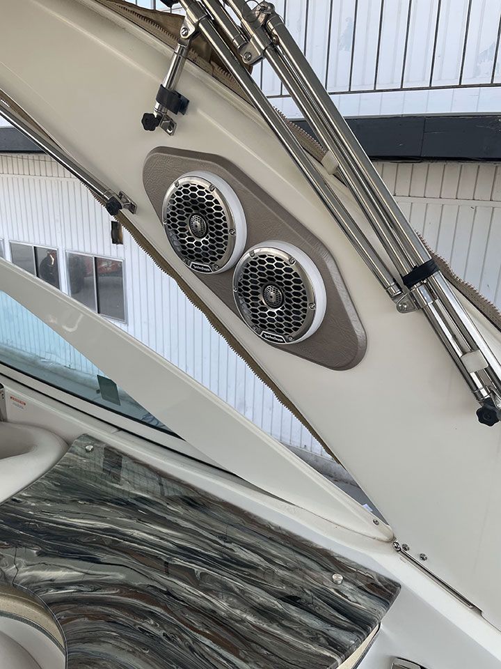 Two speakers are mounted on the side of a boat