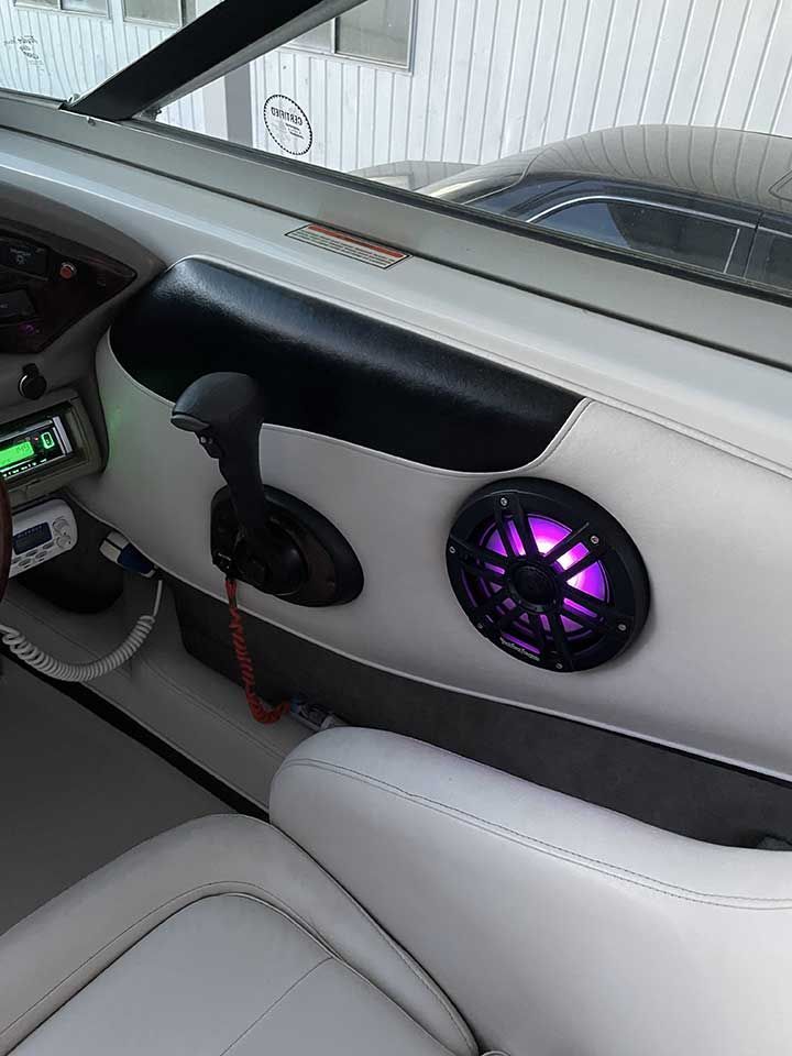 A boat with a purple speaker on the side of it
