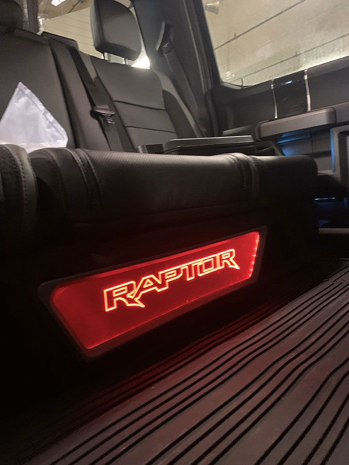 The back seat of a raptor truck with a red light on it