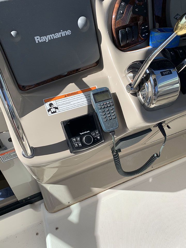 A ray marine radio is sitting on the dashboard of a boat