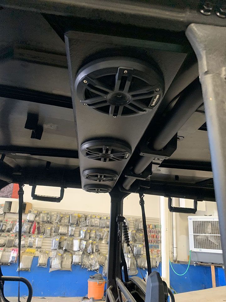 The speakers are mounted to the ceiling of the vehicle