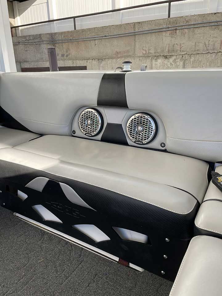 A boat with a couch and speakers on it