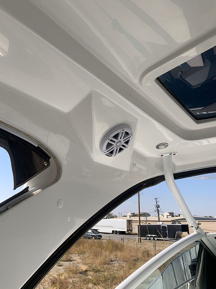 A boat with a speaker on the ceiling and a sunroof