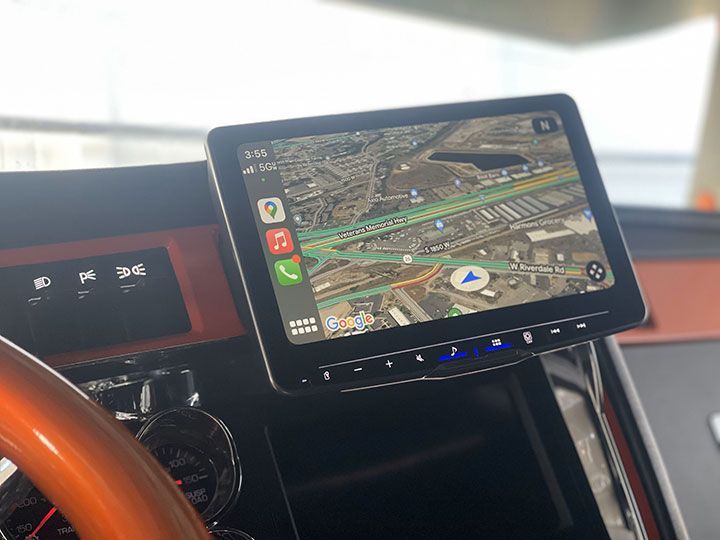 A tablet is sitting on the dashboard of a car