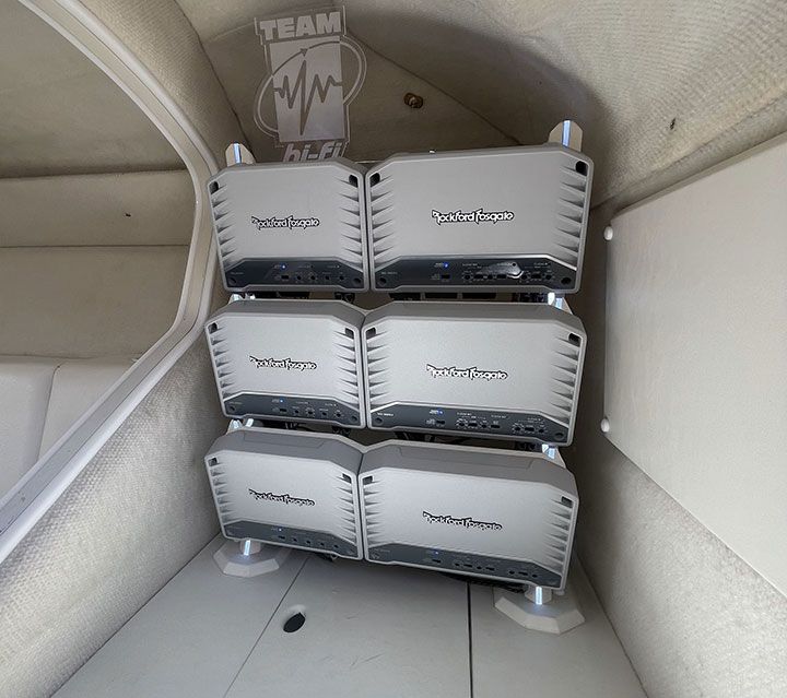 A bunch of speakers are stacked on top of each other