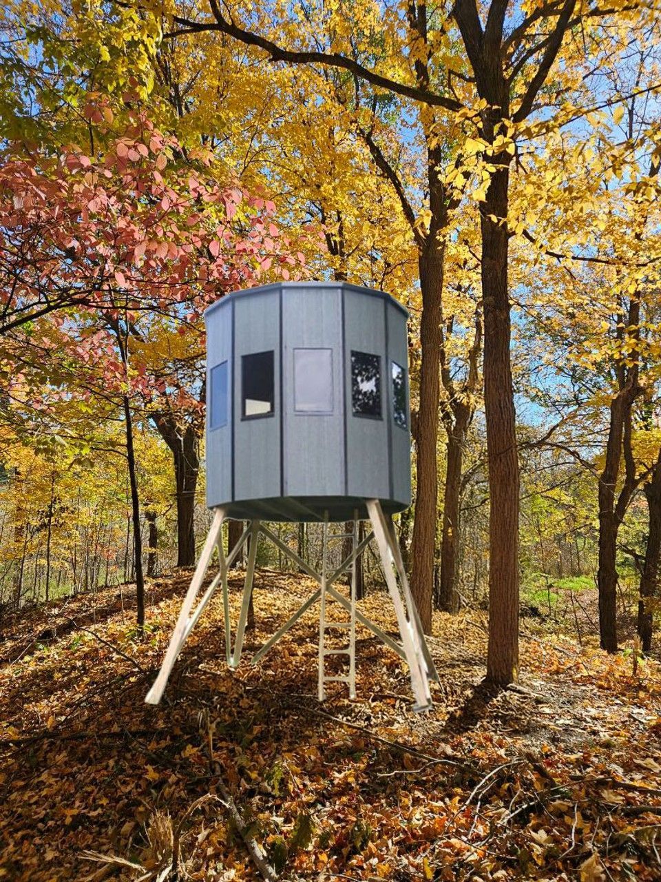Elevated, octagonal hunting blind in a forest with autumn foliage.