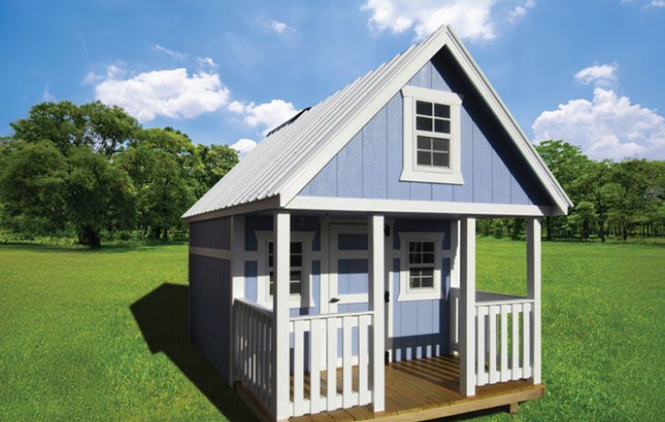 Blue and white playhouse with porch and metal roof on green grass under blue sky.