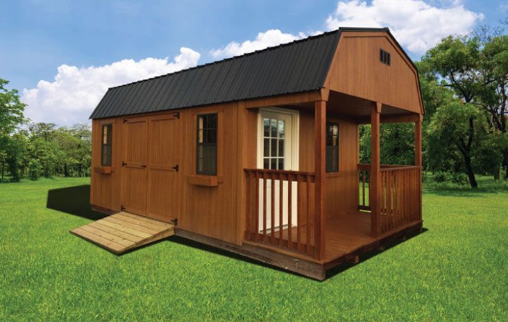 Brown wooden shed with a black roof and small porch on a green lawn.