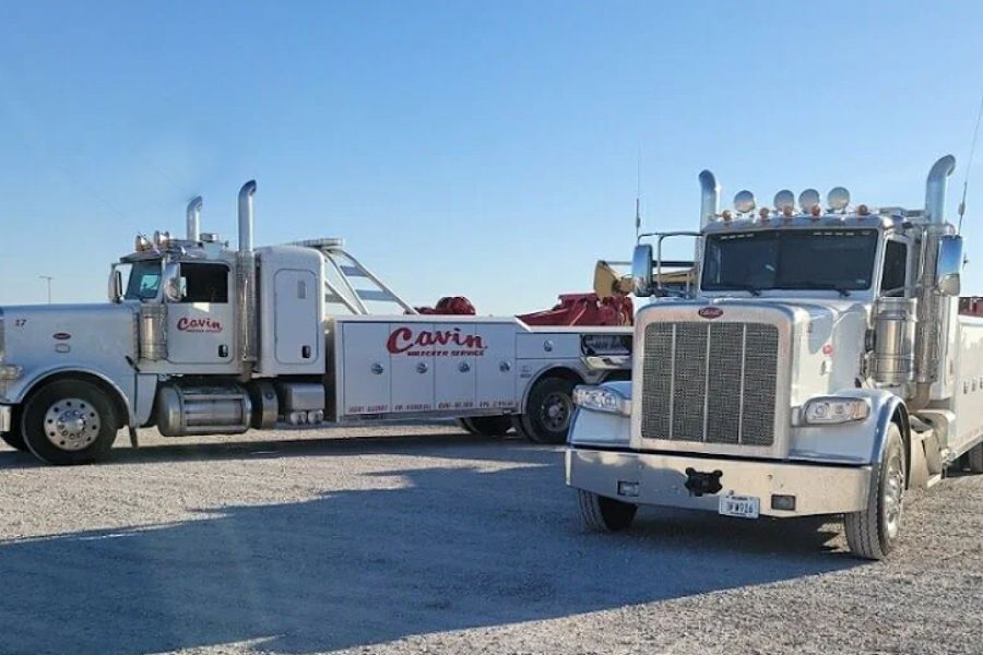 Two semi trucks are parked next to each other