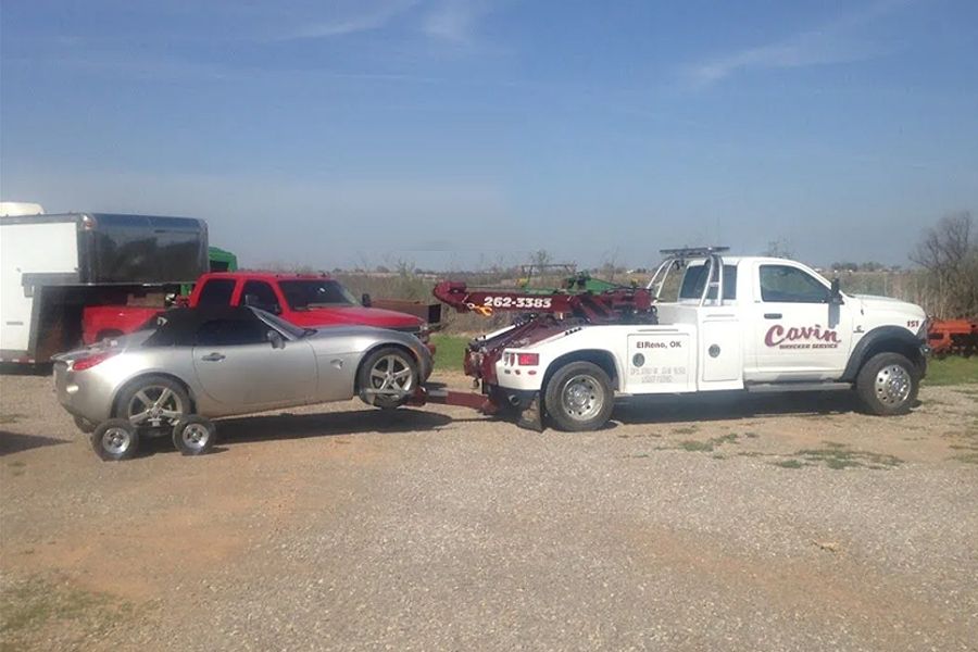 A car is being towed by a tow truck.