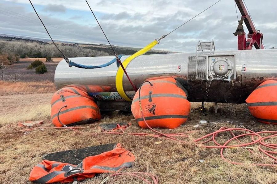 A large tank is being lifted by a crane.