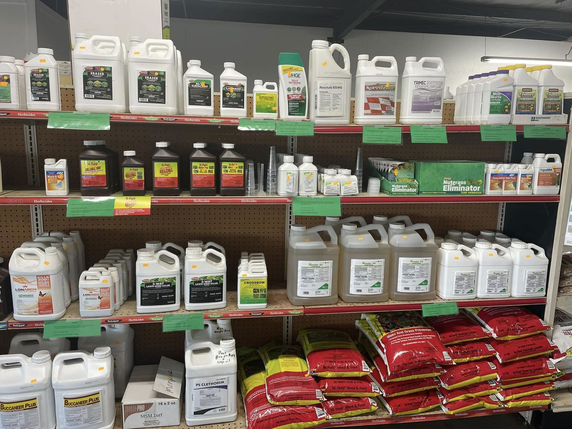 Shelves stocked with various plant care products in a store.