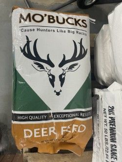 Mo' Bucks deer feed bag with black deer head logo on white and green packaging