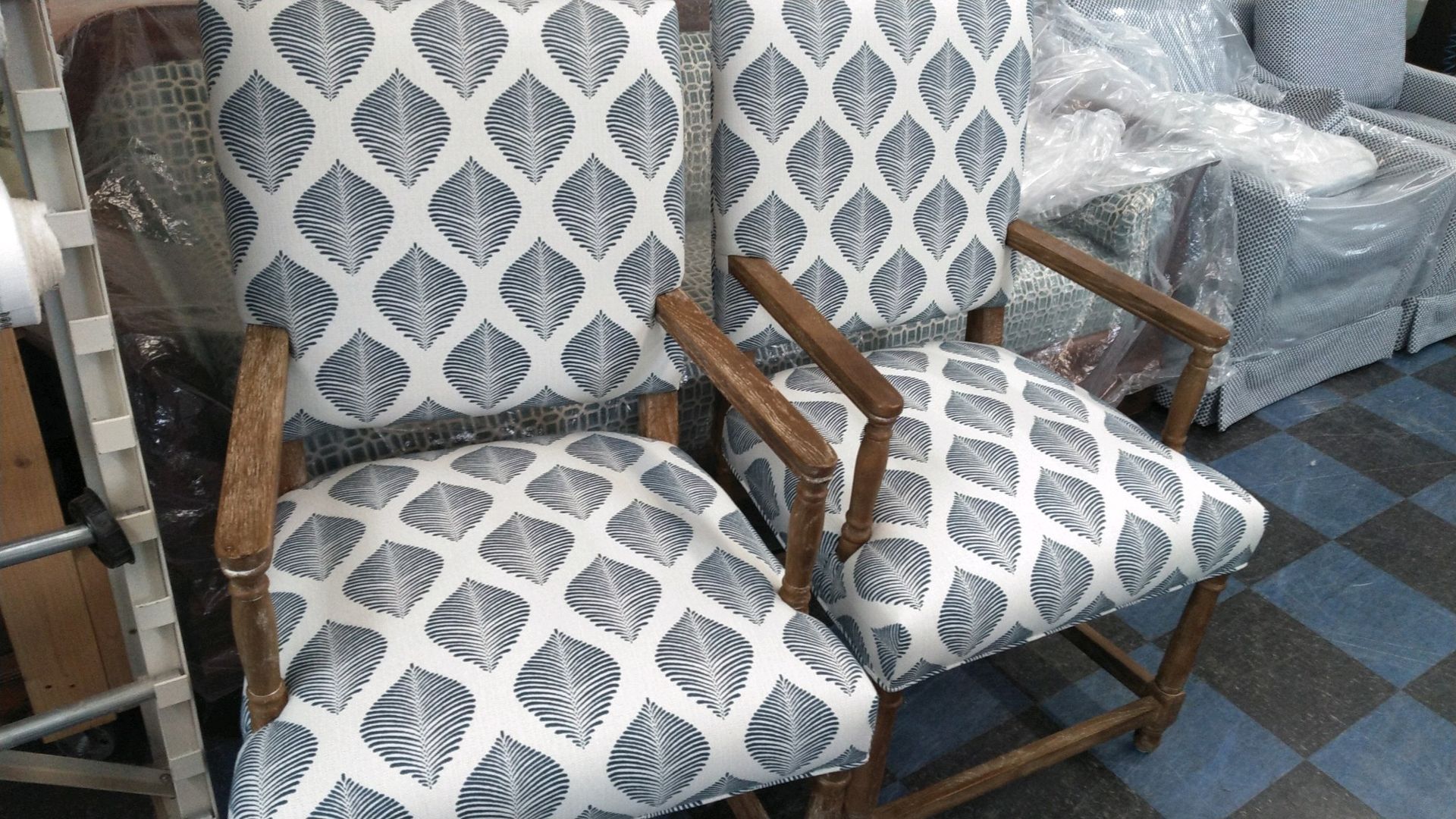 A pair of chairs with a blue and white pattern on them