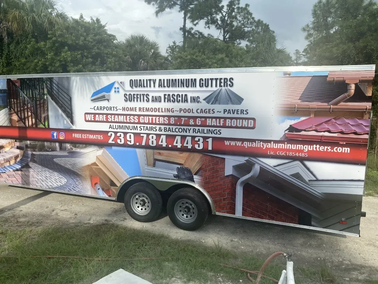 Trailer with a large “Quality Aluminum Gutters” roofing and gutter service advertisement outdoors.