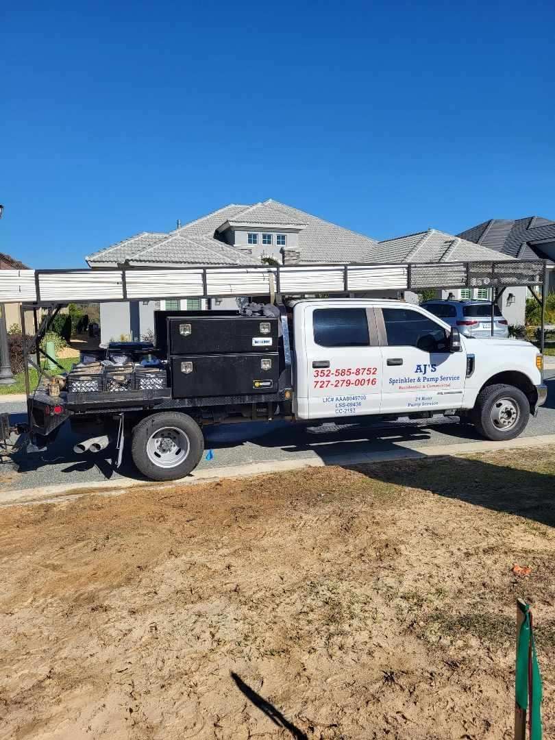 A white truck is parked in front of a house.