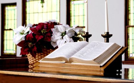 An open bible sits on an altar in a church