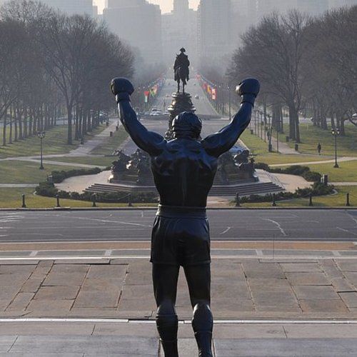 A statue of a man with his arms in the air