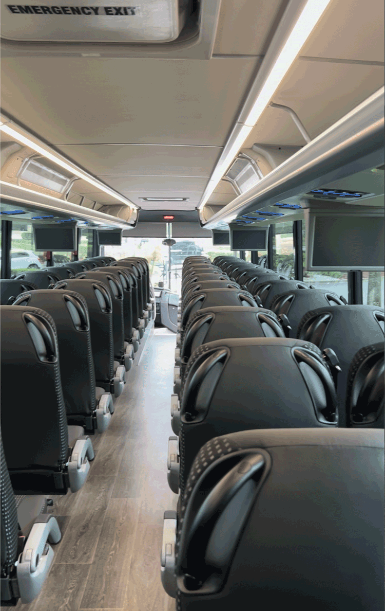 luxury Van Hool 56-passenger charter bus interior, view from the rear
