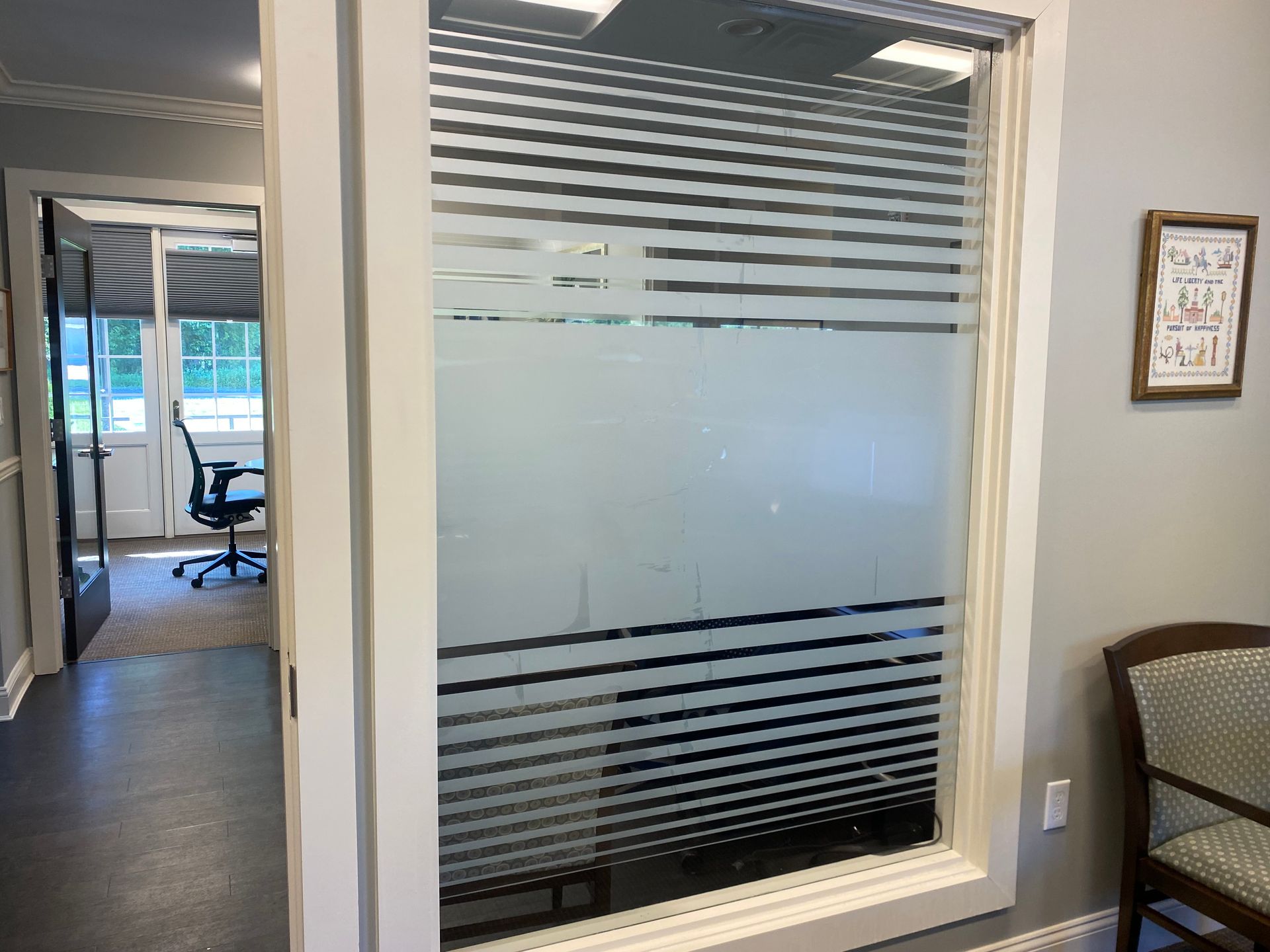 A window with a striped design on it in a room.