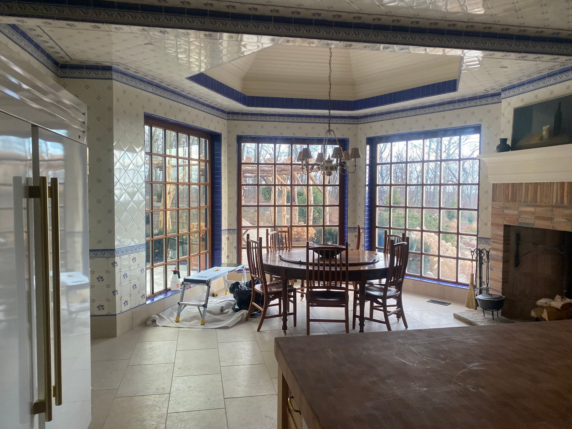 A dining room with a table and chairs and a fireplace