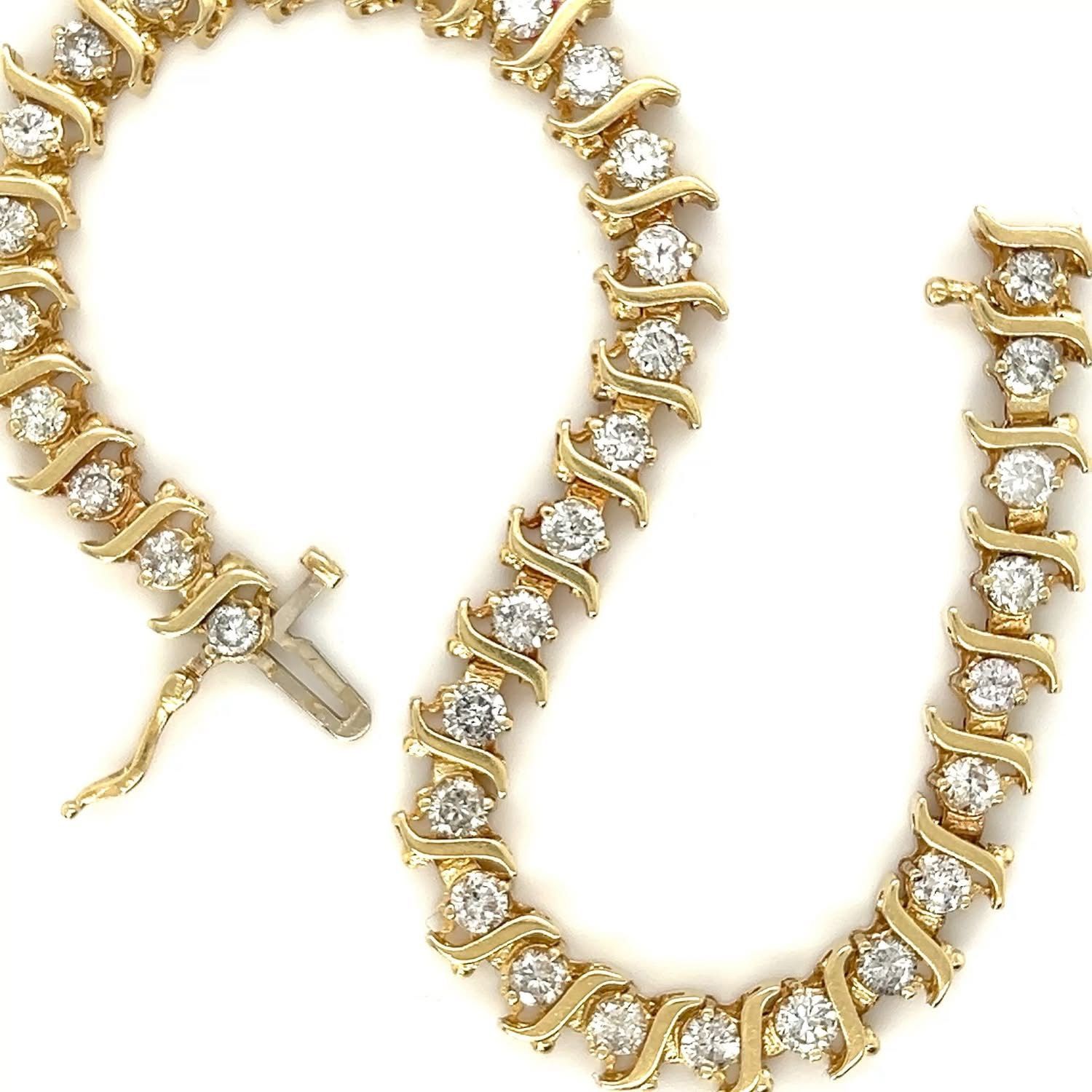 Gold bracelet with round, clear stones.