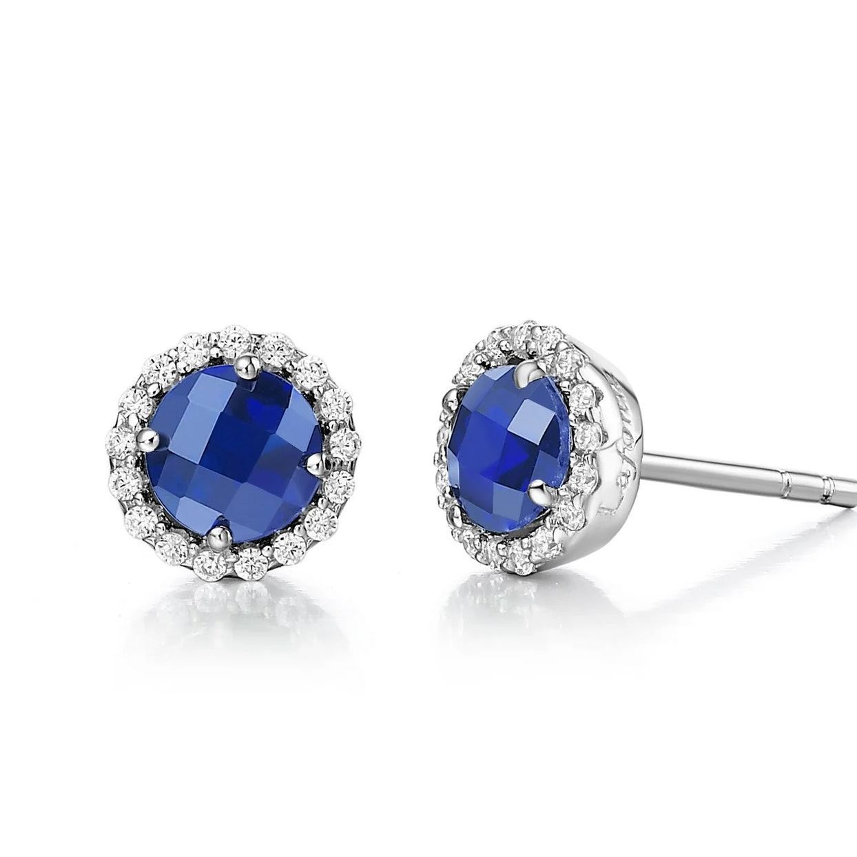 Sapphire and diamond stud earrings set in white metal.