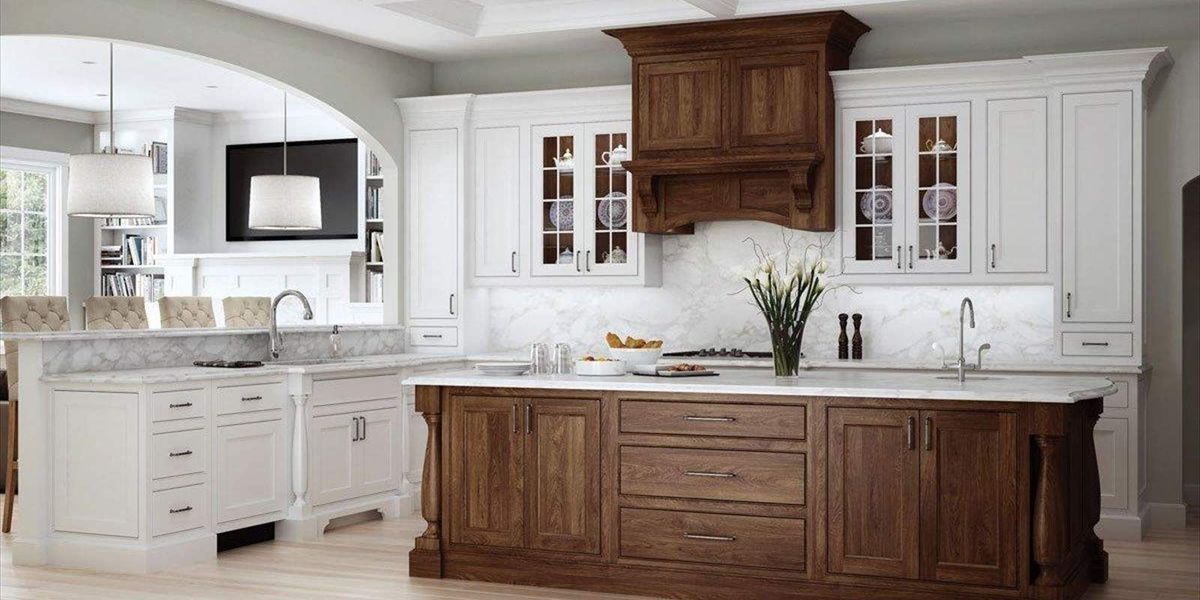 Elegant kitchen with white and brown cabinets, marble countertops, and a large island.