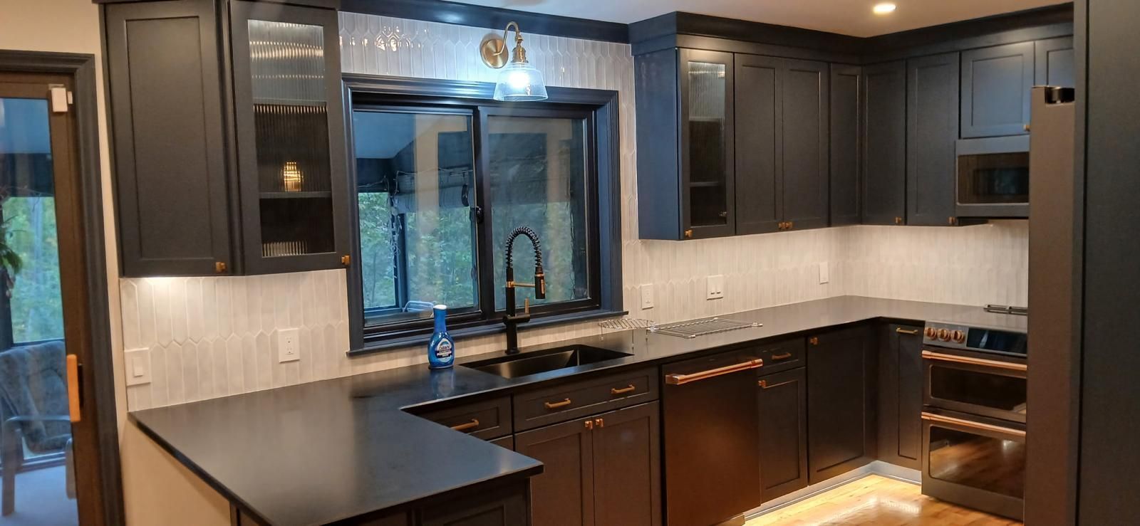 kitchen with dark brown wood cabinets and black countertop