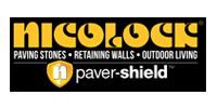 Nicolae paving stones logo with “paver-shield” on black and yellow banner