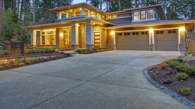 Curved concrete sidewalk through green grass in bright sunlight